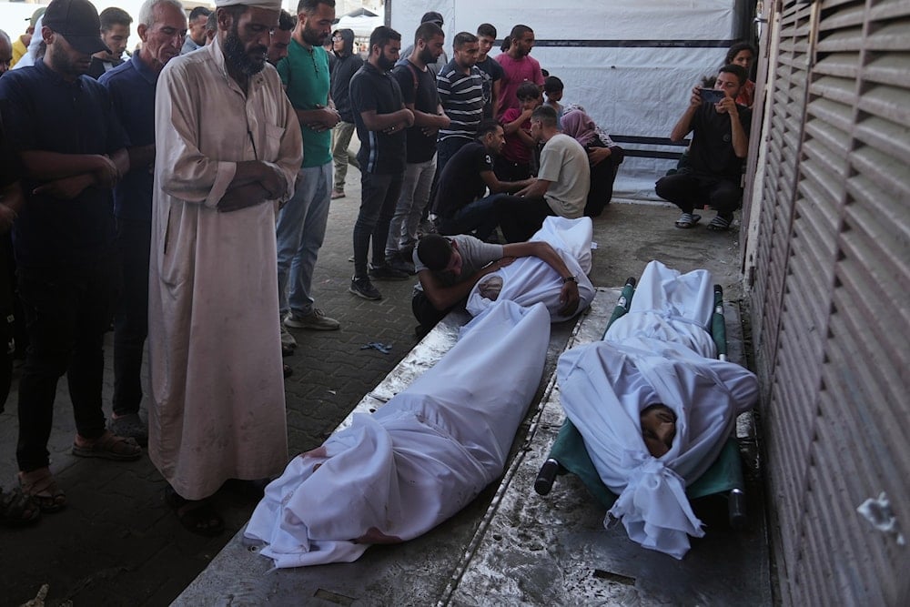 Mourners pray over the bodies of Palestinians killed by Israeli army shelling, during their funeral outside Al-Aqsa Hospital in Deir al-Balah, central Gaza Strip, Saturday, Oct. 4, 2025 (AP)