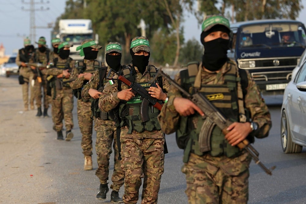 Masked militants from the Izzedine al-Qassam Brigades, a military wing of Hamas, march with their weapons along the main road of Nusseirat refugee camp, central Gaza Strip, Thursday, Oct. 28, 2021 (AP)