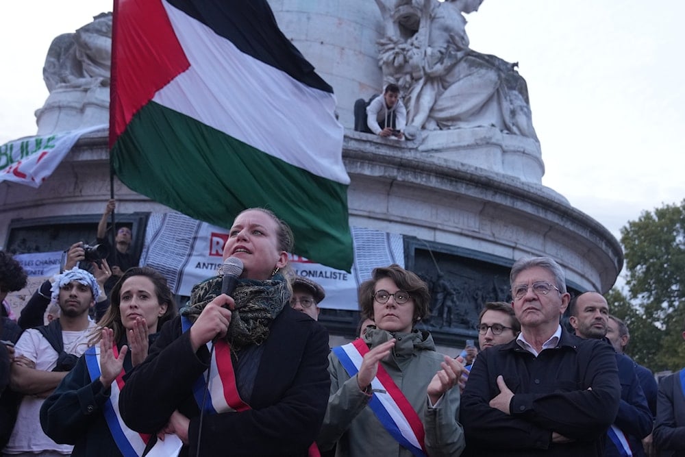 French far-left leader Jean-Luc Melenchon, listens to France Unbowed party parliament member Mathilde Panot during a demonstration after a Gaza-bound aid flotilla was illegally raided by the IOF, Thursday, Oct. 2, 2025 in Paris (AP)