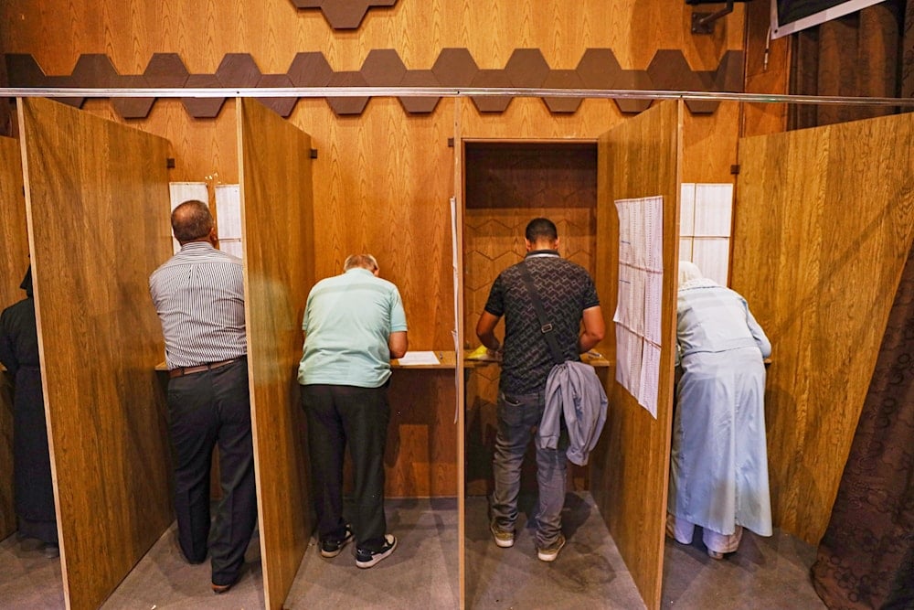 Electoral college members collect their ballots for a parliamentary election at a polling station in Aleppo, Syria, Sunday, Oct. 5, 2025 (AP)
