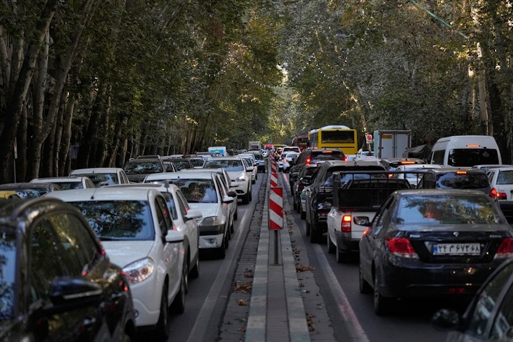 People commute in their cars during an afternoon traffic jam in northern Tehran, Iran, Sunday, September 28, 2025 (AP)