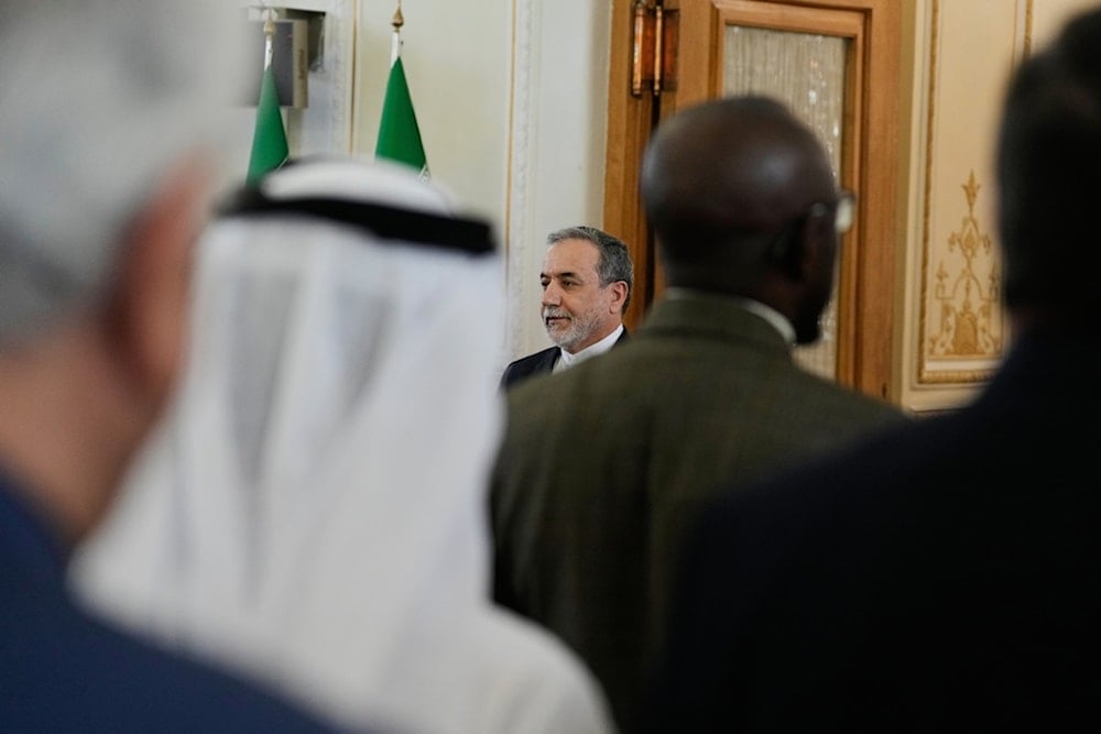 Iranian Foreign Minister Abbas Araghchi, center, and ambassadors and representatives of foreign countries in Tehran listen to Iran's national anthem at the start of their meeting in Tehran, Iran, Sunday, October 5, 2025 (AP)