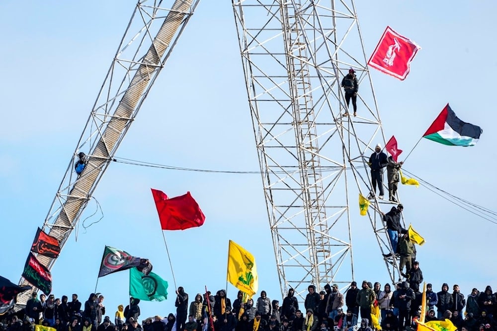 Mourners wave Hezbollah and a Palestinian flag during the funeral of Hezbollah former leader Sayyed Hassan Nasrallah and his successor Sayyed Hashem Safieddine in the Sports City Stadium in Beirut, Lebanon, Sunday, February 23, 2025 (AP)