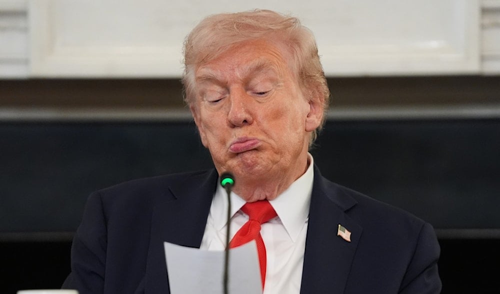 President Donald Trump reads a note handed to him by Secretary of State Marco Rubio during a roundtable meeting on antifa in the State Dining Room at the White House, Wednesday, Oct. 8, 2025, in Washington. (AP)