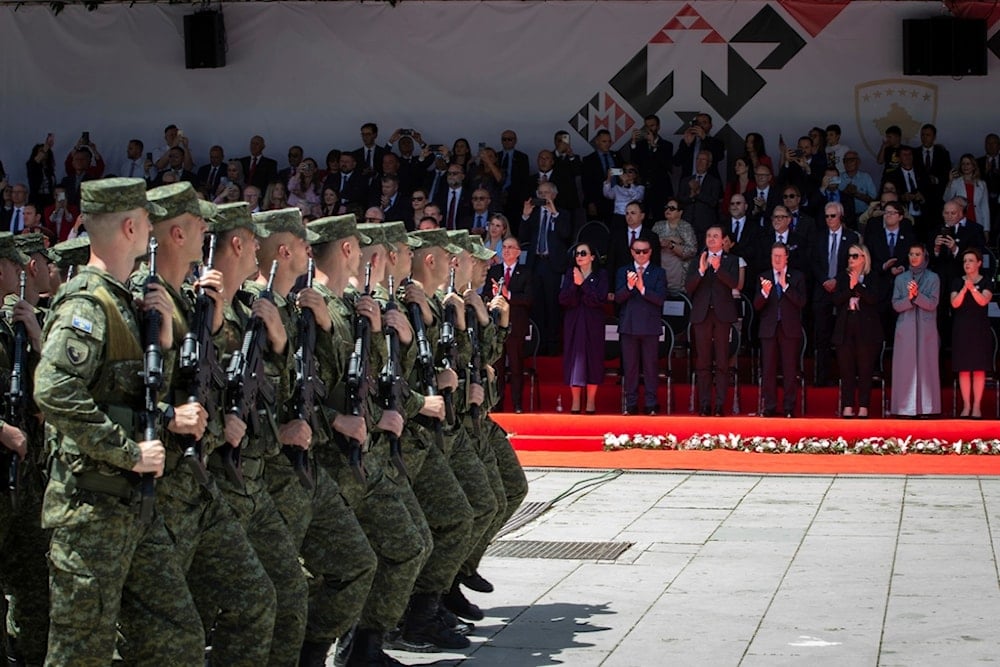 Kosovo Army members march at a military parade during a ceremony marking the 25th anniversary of the NATO-led KFOR forces entering Kosovo in the capital, Pristina, Kosovo, Wednesday, June 12, 2024 (AP)