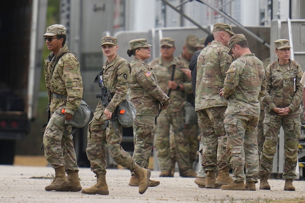 National Guard troops arrive in Chicago.