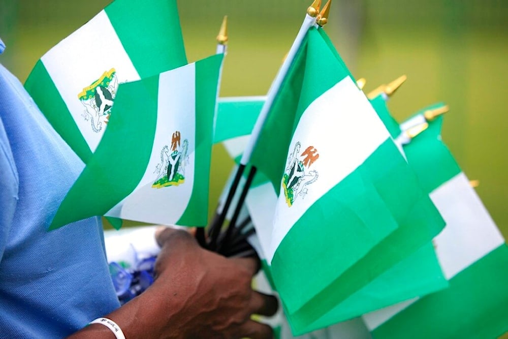 An unidentified woman sells Nigerian national flags, during an event to mark Nigeria independence day, in Lagos, Nigeria. Tuesday, Oct. 1, 2013. (AP)