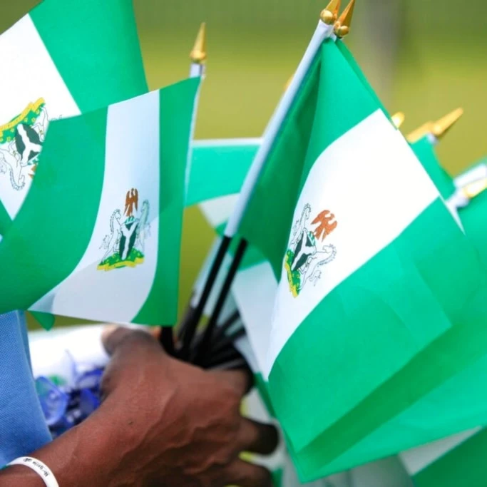 An unidentified woman sells Nigerian national flags, during an event to mark Nigeria independence day, in Lagos, Nigeria. Tuesday, Oct. 1, 2013. (AP)