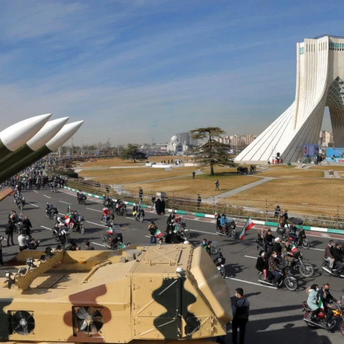 Iranians drive past missiles by their motorcycle during a rally marking the 42nd anniversary of the Islamic Revolution, at Azadi (Freedom) Square in Tehran, Iran, Wednesday, February 10, 2021 (AP)