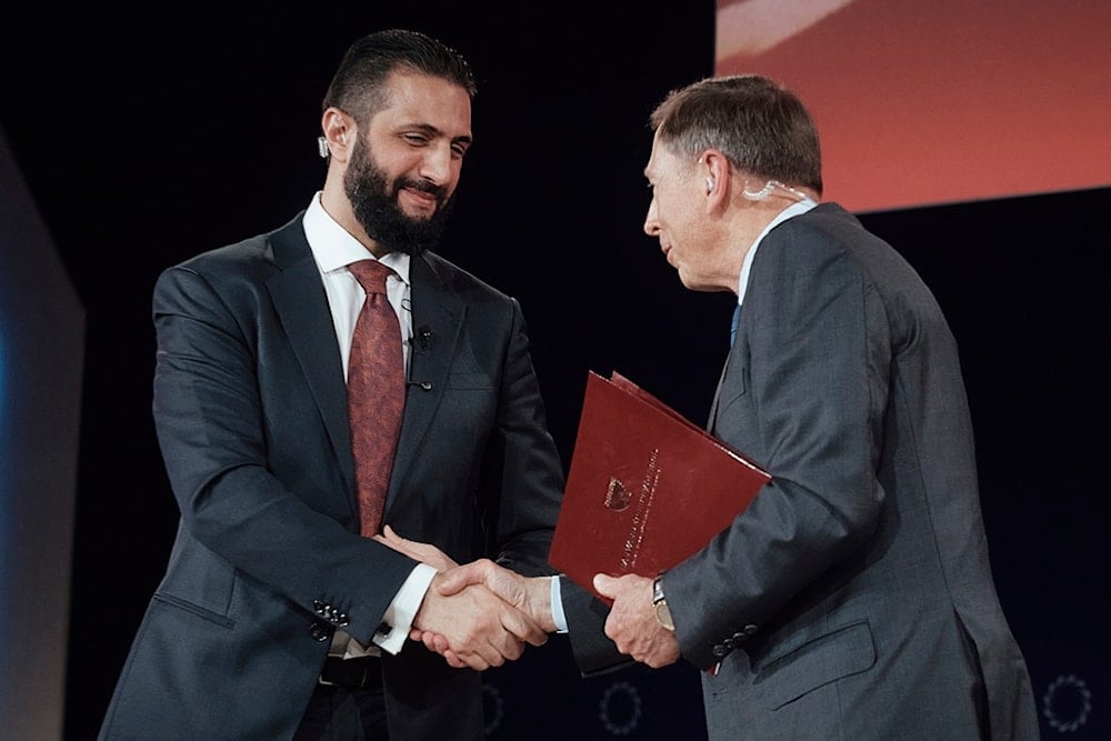Interim Syria President Ahmad al-Sharaa, left, shakes hands with former US Army General, David Petraeus during the Concordia Annual Summit in New York, Monday, September 22, 2025 (AP)