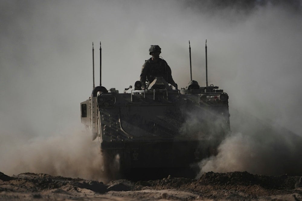 Israeli troops move with armored personnel carriers near the Gaza border on Thursday, May 8, 2025. (AP Photo/Ariel Schalit)