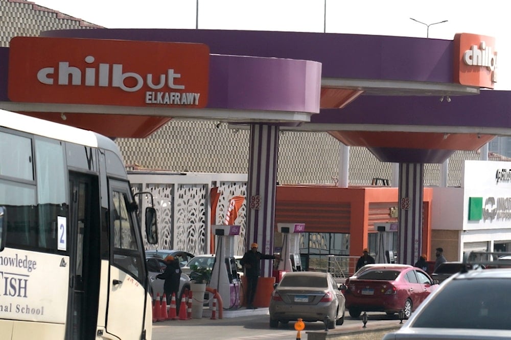 Vehicles wait at Chillout gasoline station, one of the Armed Forces-owned projects, in Cairo, Egypt, Tuesday, March 21, 2023. (AP Photo)