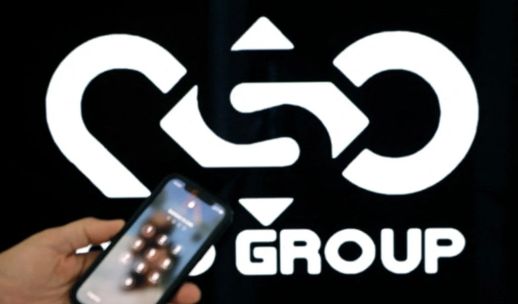 A photographic illustration shows a mobile phone near the NSO Group company logo in Occupied Palestine on February 9, 2022. (JACK GUEZ / AFP)