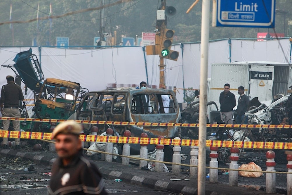 A policeman stands guard as investigators examine the site of Monday's car explosion near the historic Red Fort, in New Delhi, India, Tuesday, Nov. 11, 2025. (AP Photo)