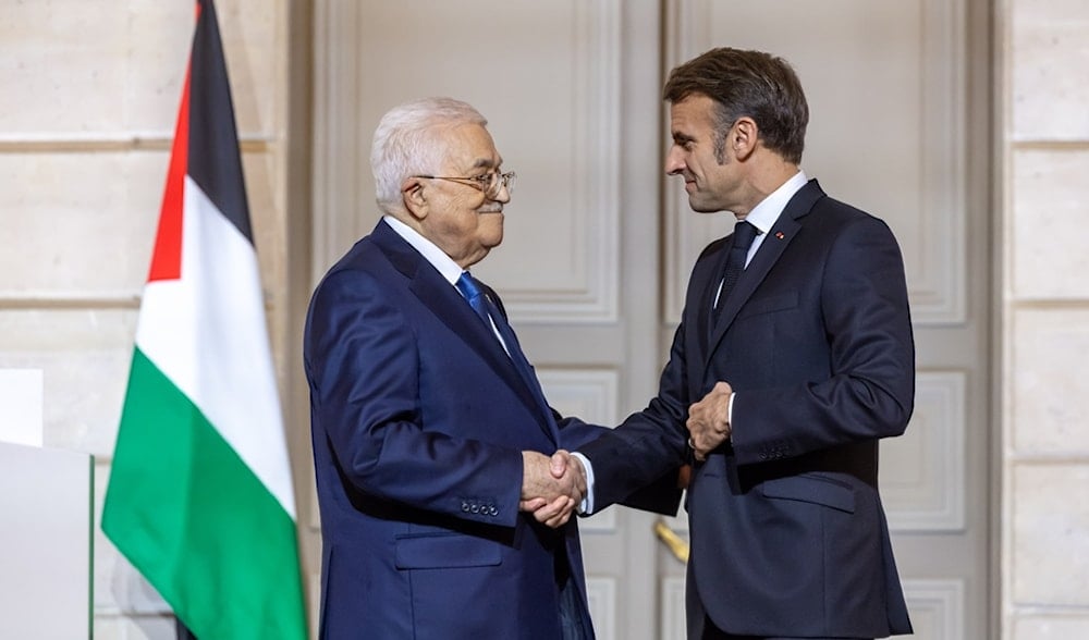 French President Emmanuel Macron, right, shakes hands with Palestinian President Mahmoud Abbas after a joint statement at the Elysee Palace in Paris, Tuesday Nov. 11 2025. (AP)