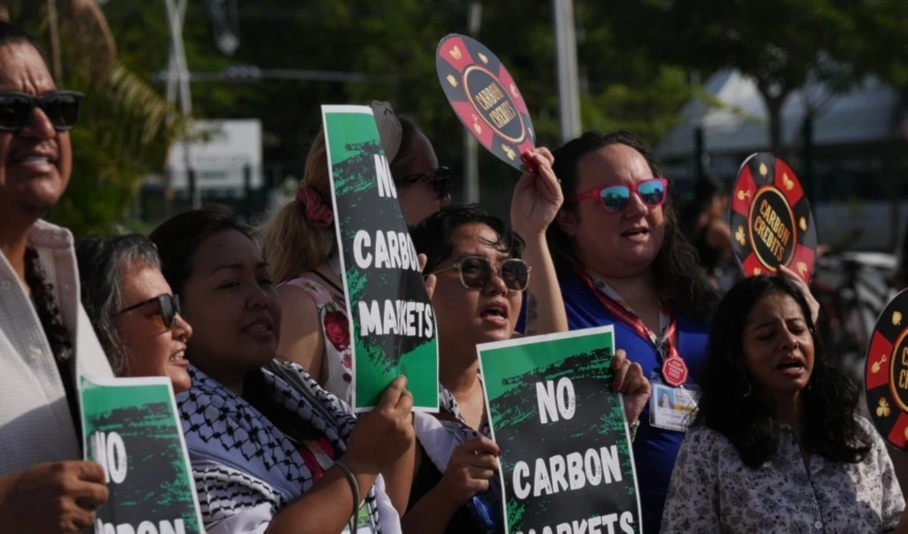 Demonstrators protest against carbon markets outside the venue for the COP30 U.N. Climate Summit, Tuesday, Nov. 11, 2025, in Belem, Brazil. (AP Photo/Fernando Llano)