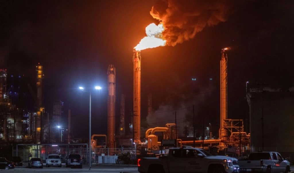 Flames rise from the Chevron refinery in El Segundo, Calif., Thursday, Oct. 2, 2025. (AP Photo/Ethan Swope)