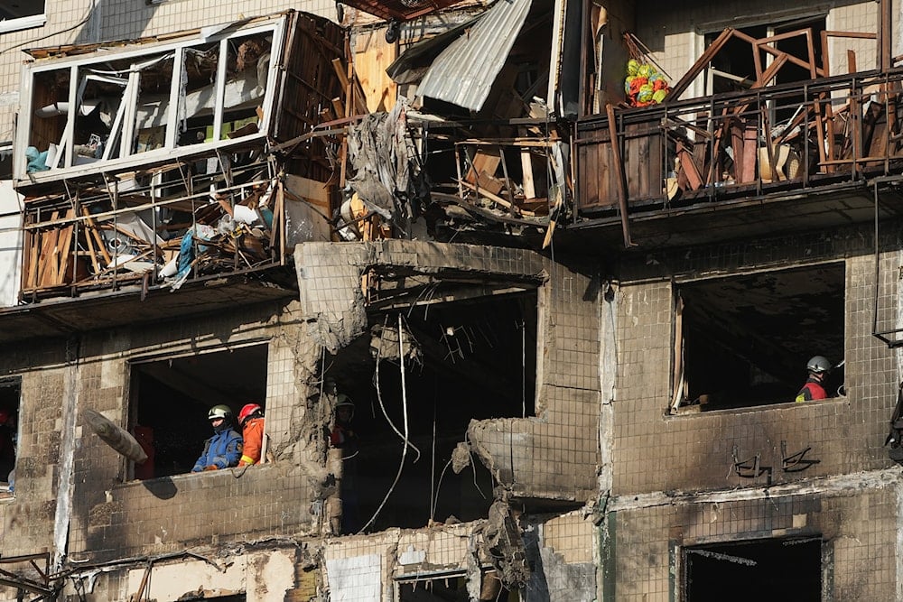 Rescuers work on the scene of a building damaged after a Russian attack in Kyiv, Ukraine, on Friday, Nov. 14, 2025 (AP)