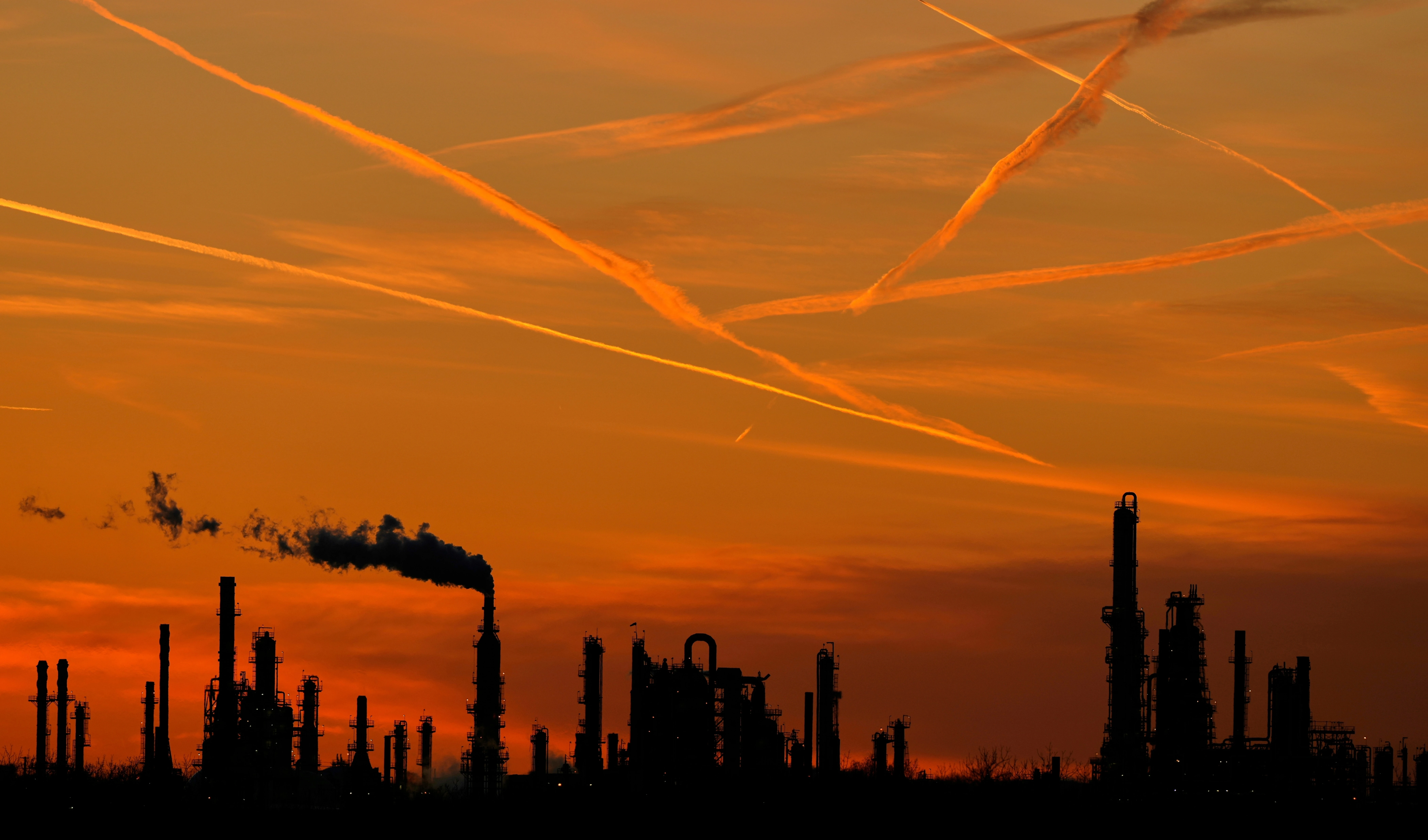 The HF Sinclair El Dorado oil refinery is silhouetted against the sky at sunset Friday, March 21, 2025, in El Dorado, Kan (AP)