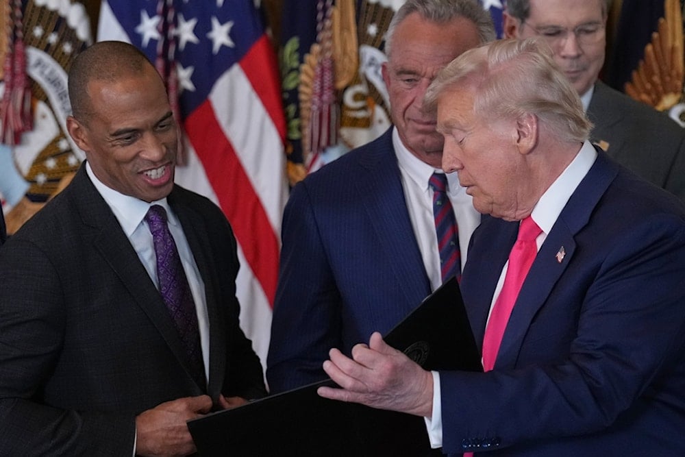 US President Donald Trump talks with Housing and Urban Development Secretary Scott Turner and Health and Human Services Secretary RFK, at an event on foster care in the East Room at the White House, Thursday, November 13, 2025, in Washington (AP)