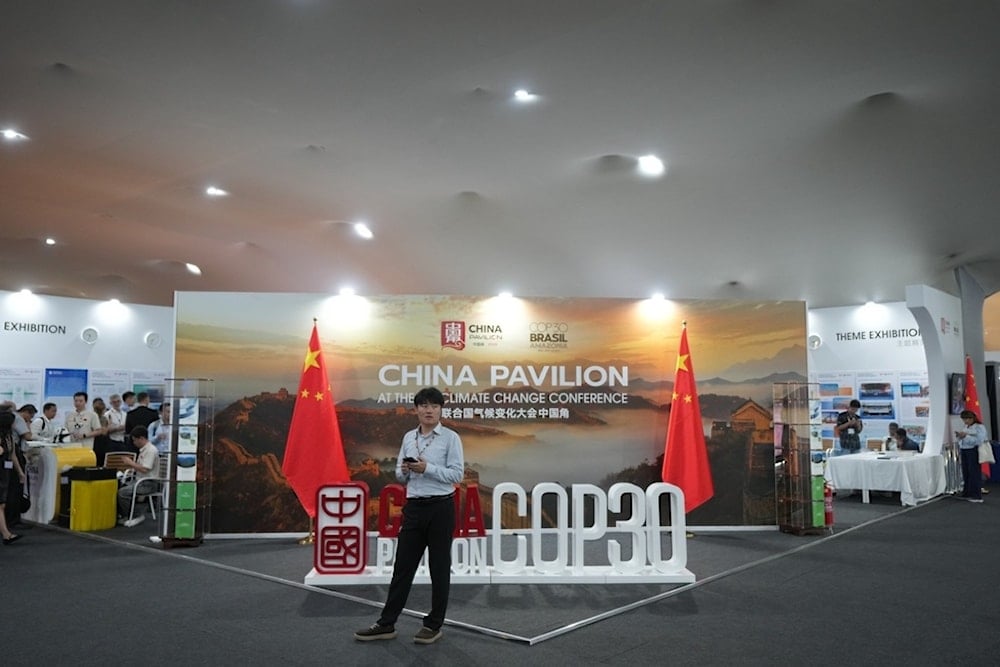 A person stands outside the China Pavilion at the COP30 UN Climate Summit, Thursday, November 13, 2025, in Belem, Brazil. (AP Photo/Fernando Llano)