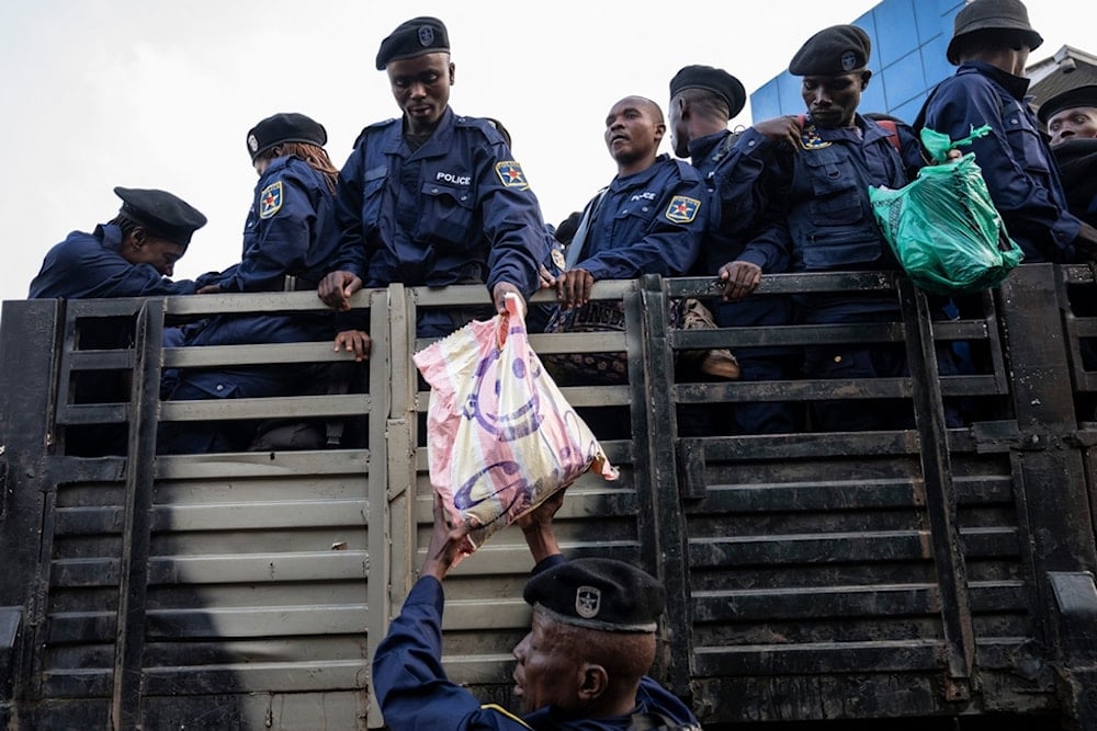 Former members of the Armed Forces of the Democratic Republic of Congo (FARDC) and police officers who allegedly surrendered to M23 rebels arrive in Goma, Congo, Sunday, February 23, 2025. (AP Photo/Moses Sawasawa)