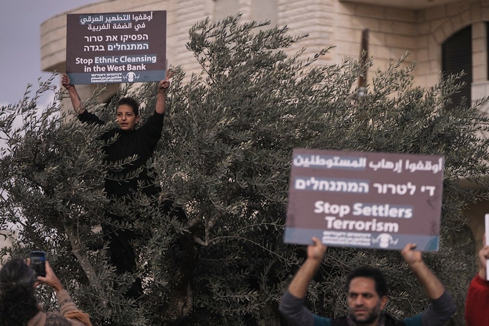 Activists take part in a protest against the Israeli settlers violence as they gather in the West Bank town of Beit Jala, Friday, Nov. 14, 2025 (AP)