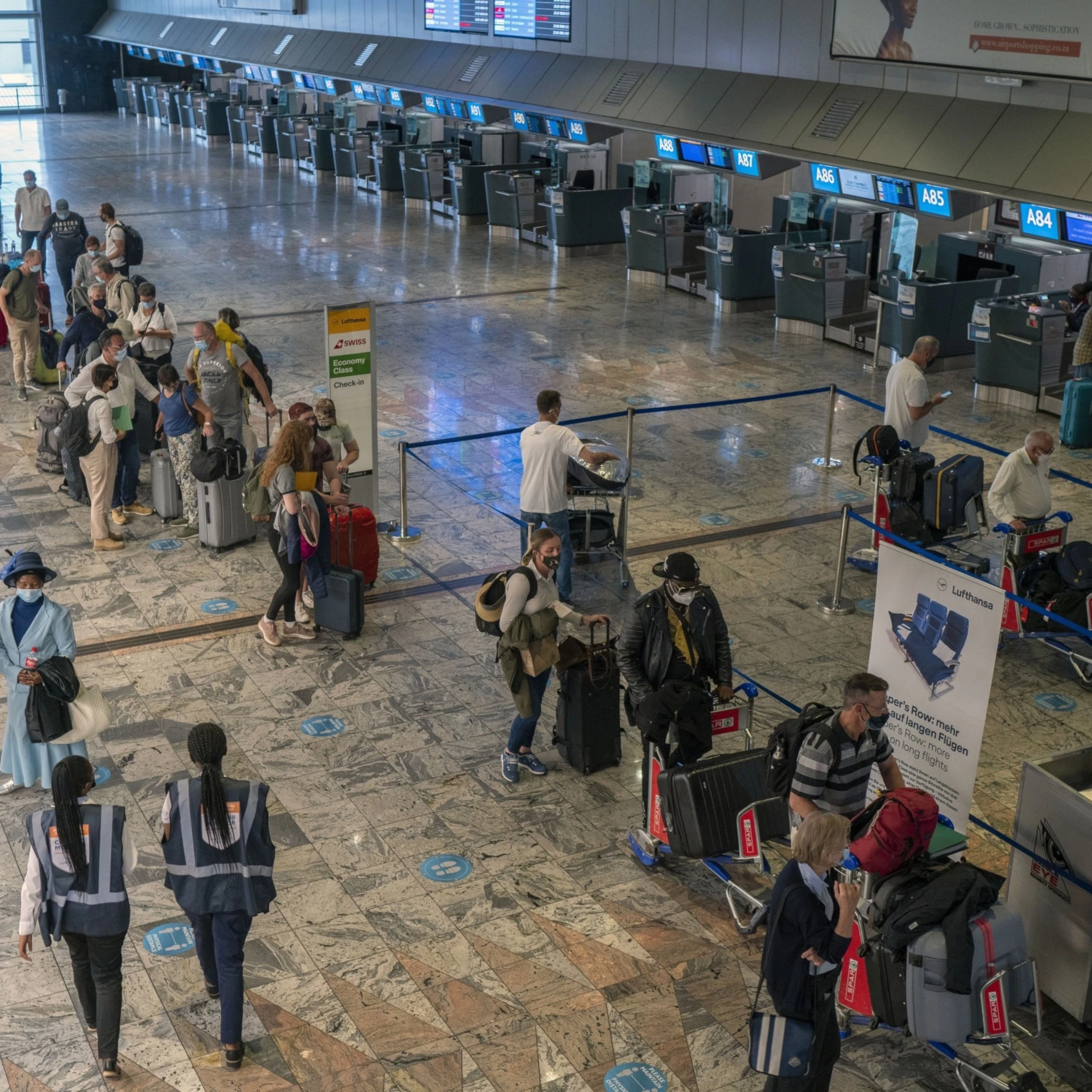 Passengers check in at a counter at Johannesburg's OR Tambo International Airport, South Africa, November 29, 2021. (AP Photo)