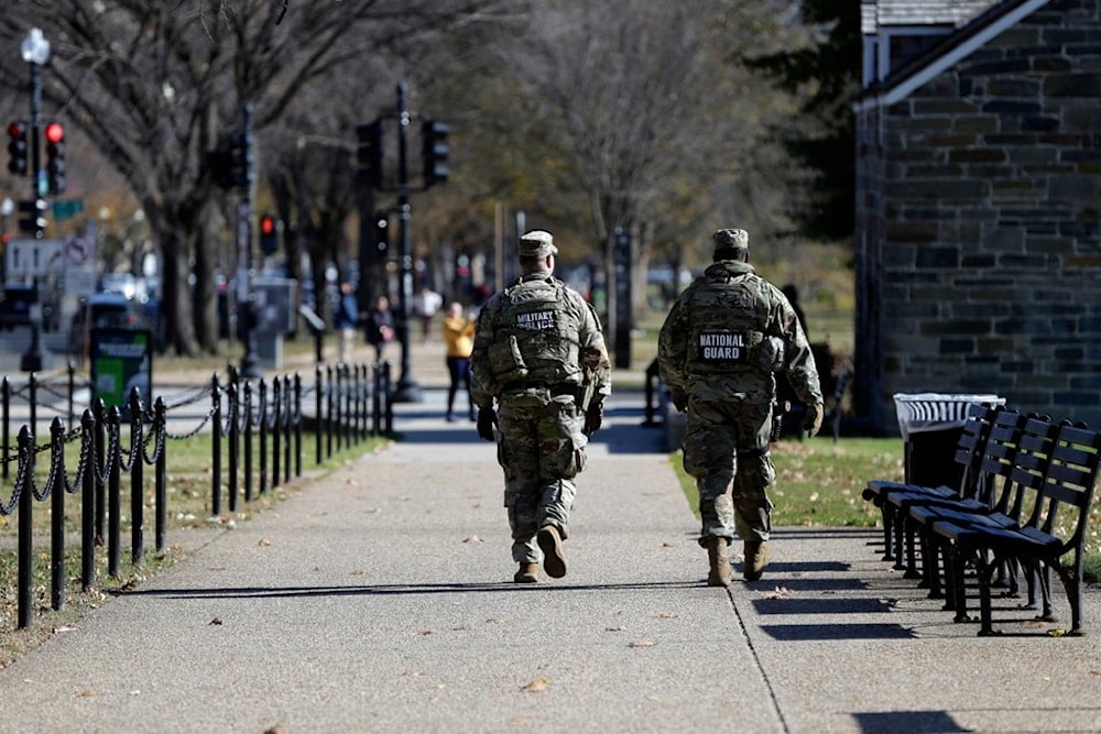 National Guard soldiers patrol on the National Mall, Thursday, November 13, 2025, in Washington. (AP Photo/Rahmat Gul)