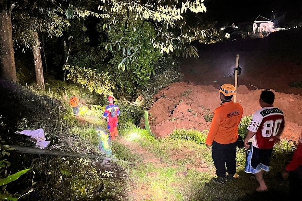 In this undated photo released by the Indonesian National Search and Rescue Agency (BASARNAS) on Friday, November 14, 2025, rescuers search for victims after a landslide on Thursday, November 13 hit a village in Cilacap, Indonesia. (BASARNAS via AP)