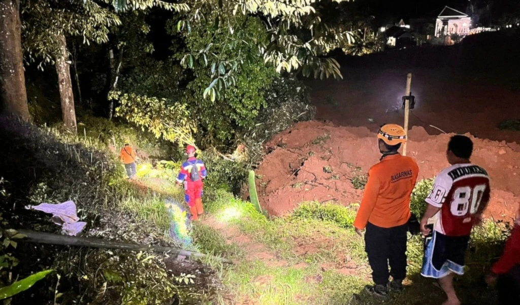In this undated photo released by the Indonesian National Search and Rescue Agency (BASARNAS) on Friday, November 14, 2025, rescuers search for victims after a landslide on Thursday, November 13 hit a village in Cilacap, Indonesia. (BASARNAS via AP)