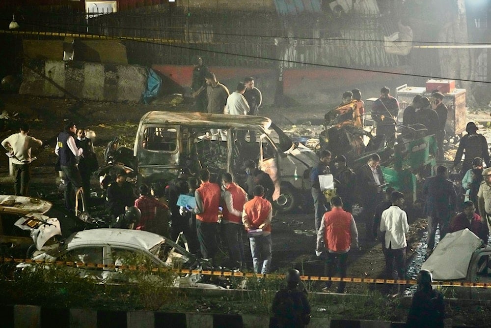Security officers inspect the scene of a car explosion, reportedly killing eight people, near the historic Red Fort in New Delhi, India, November 10, 2025. (AP Photo/Manish Swarup)