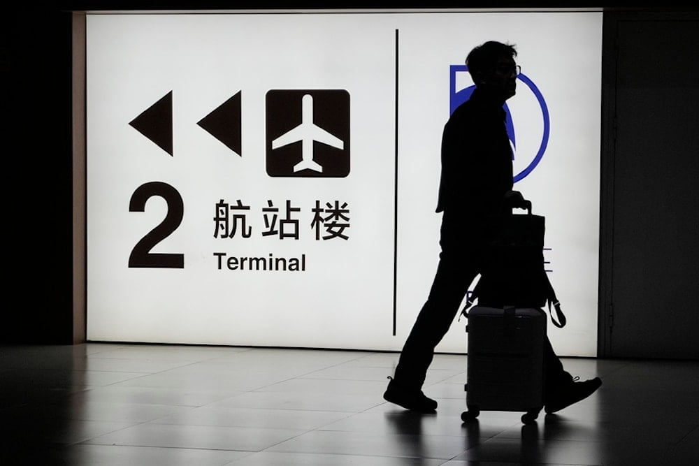 A passenger arrives at the Capital Airport in Beijing on Nov. 7, 2025. (AP Photo/Ng Han Guan)