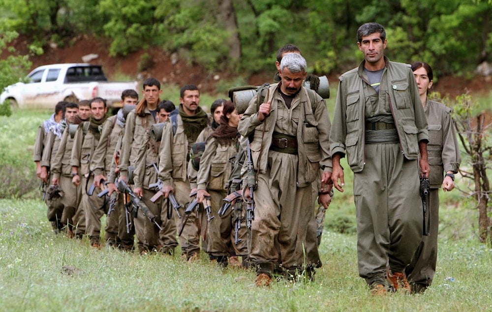  A group of armed Kurdish fighters from the Kurdistan Workers Party (PKK) enter northern Iraq in the Heror area, northeast of Dahuk, 260 miles (430 kilometers) northwest of Baghdad, Iraq, on May 14, 2013. (AP Photo/Ceerwan Aziz, File)