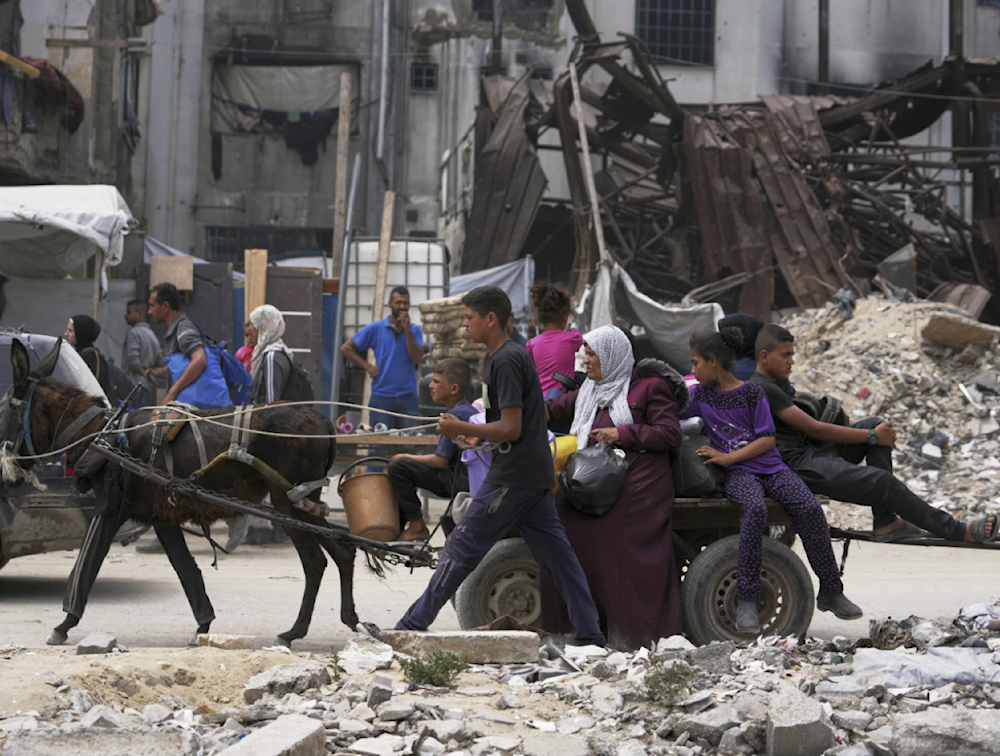 Displaced Palestinians fleeing Beit Lahia during Israeli bombings arrive in Jabalia in northern Gaza on May 18, 2025. (AP)