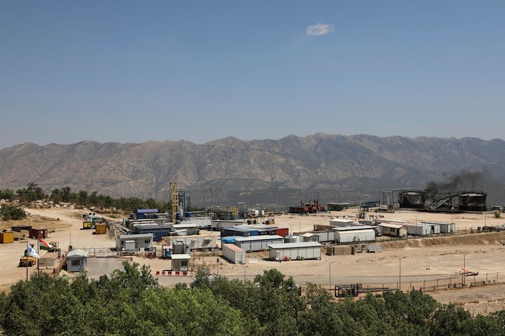 Black smoke rises from damaged oil storage tanks following drone attacks on an oil field in the Sarsang district of Iraq's semi-autonomous Kurdish region, Thursday, July 17, 2025 (AP)