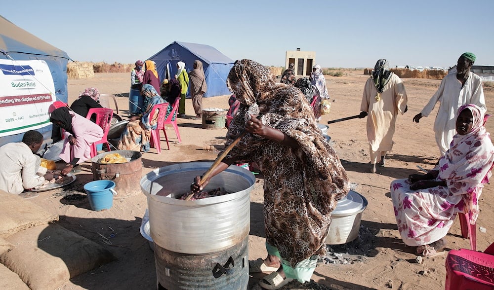 Sudanese women displaced from El-Fasher cook meals at a community kitchen inside the newly established El-Afadh camp in Al Dabbah, in Sudan's Northern State, Sunday, Nov. 16, 2025. (AP)