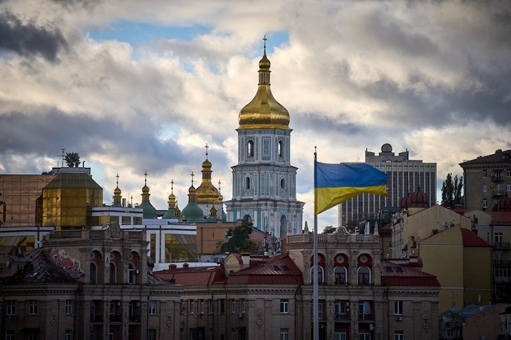 Ukrainian national flags waves on Independence square against the background of ancient St.Sophia Cathedral in central Kiev, Ukraine, Monday, Oct. 13, 2025. (AP Photo/Efrem Lukatsky)
