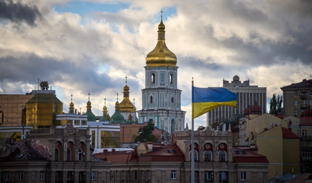 Ukrainian national flags waves on Independence square against the background of ancient St.Sophia Cathedral in central Kiev, Ukraine, Monday, Oct. 13, 2025. (AP Photo/Efrem Lukatsky)