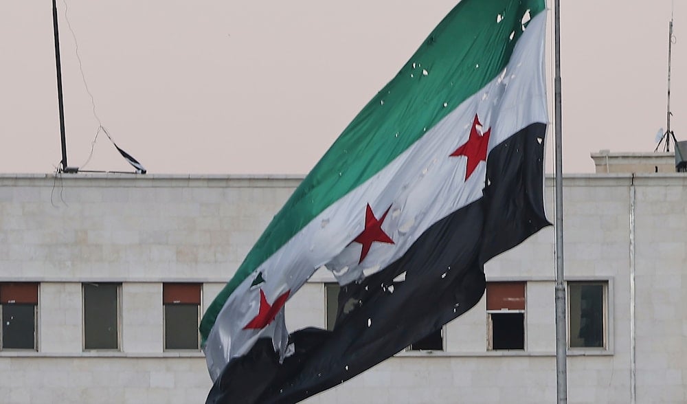 A torn Syrian flag waves at the Syrian Defense Ministry building which heavily damaged after alleged Israeli airstrikes in Damascus, Syria, July 16, 2025. (AP)