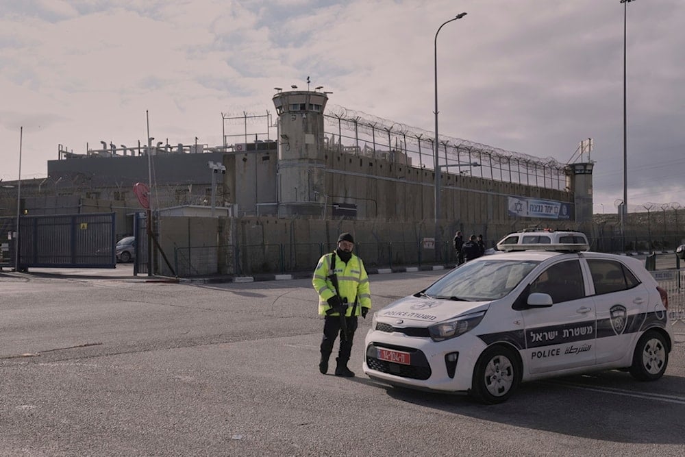 Israeli officer stands outside Ofer military prison near Occupied Al Quds on Saturday, February 8, 2025. (AP Photo/Mahmoud Illean)