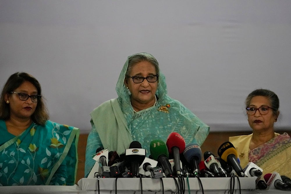 Former Bangladesh Prime Minister Sheikh Hasina, center, is flanked by her daughter Saima Wazed Putul, left, and sister Sheikh Rehana as she speaks to the media after casting her vote in Dhaka, Bangladesh, Sunday, January 7, 2024. (AP Photo/Altaf Qadri)