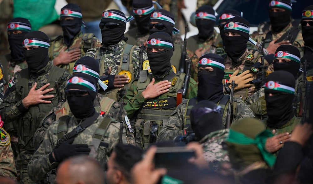 Hamas fighters stand in formation as they prepare for the ceremony of Israeli captive hand over to the Red Cross in Nuseirat, central Gaza Strip, Feb. 22, 2025. (AP)