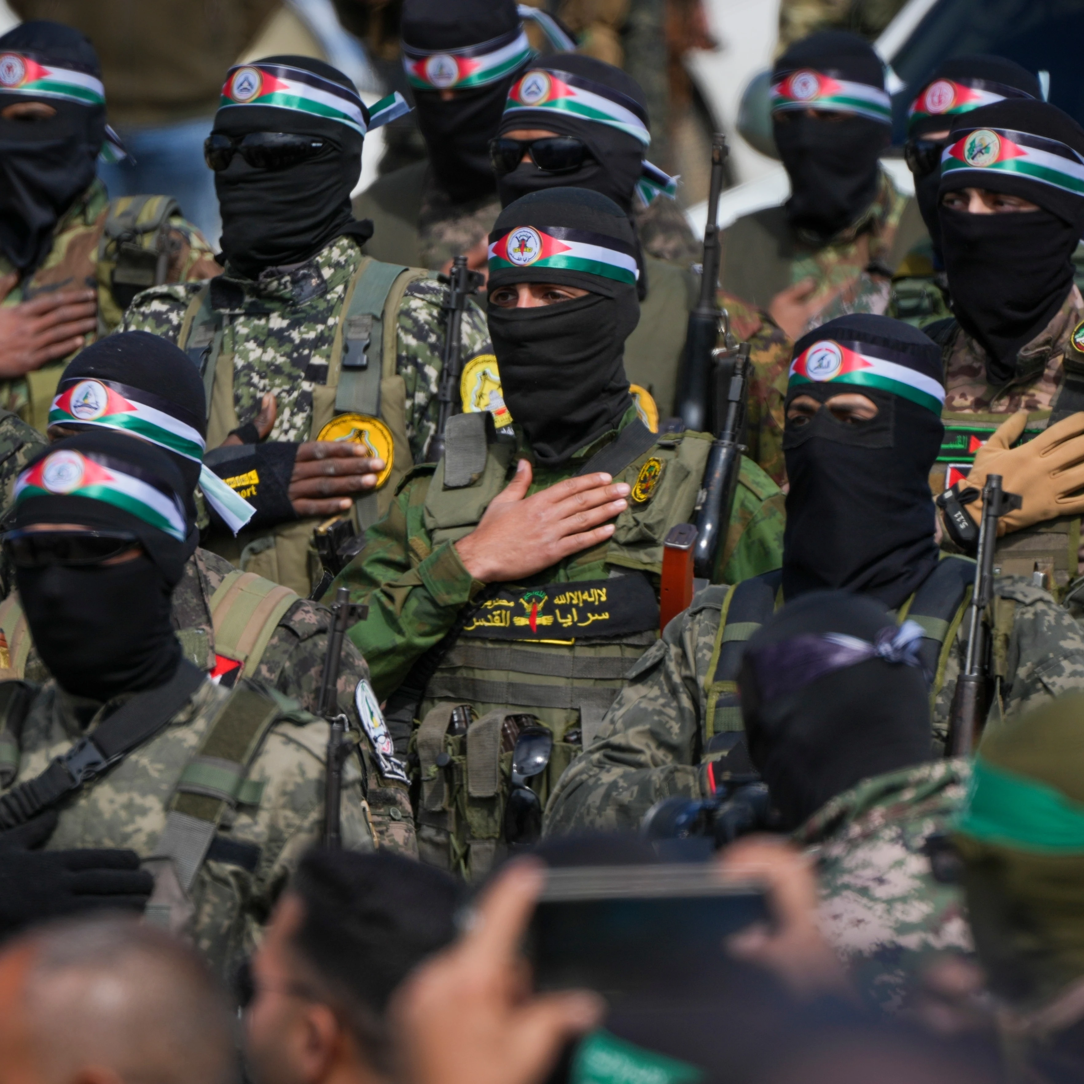Hamas fighters stand in formation as they prepare for the ceremony of Israeli captive hand over to the Red Cross in Nuseirat, central Gaza Strip, Feb. 22, 2025. (AP)