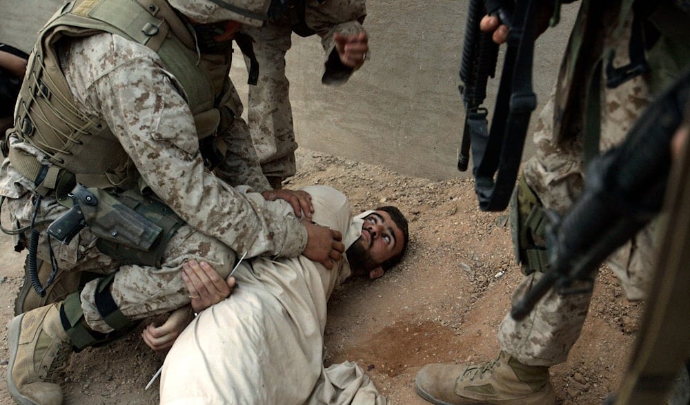 US Marines of the fifth division arrest an Iraqi man in the center of Fallujah, Iraq, Thursday, Nov. 11, 2004. (AP)