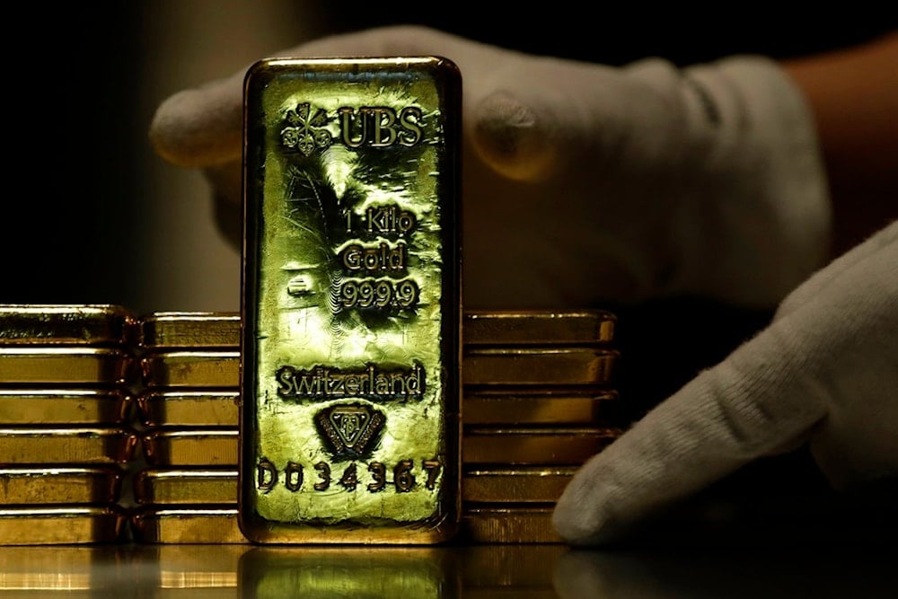 Employees of ProAurum gold house prepares 1 Kg gold bars of 999.9 purity in the safe deposit boxes room in Munich, Germany, Thursday, Dec. 13, 2018. (AP Photo/Matthias Schrader)