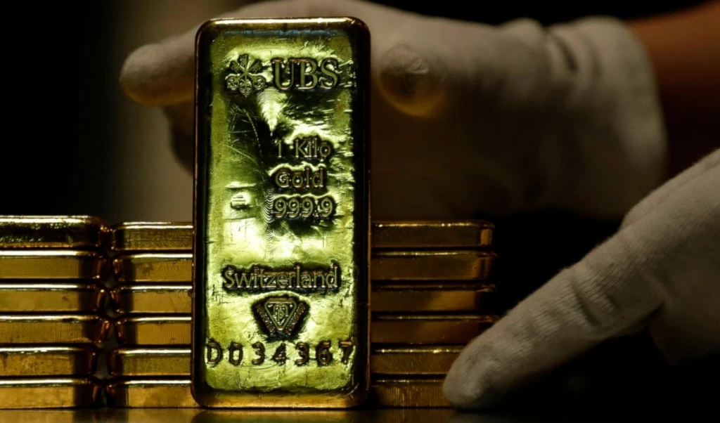 Employees of ProAurum gold house prepares 1 Kg gold bars of 999.9 purity in the safe deposit boxes room in Munich, Germany, Thursday, Dec. 13, 2018. (AP Photo/Matthias Schrader)