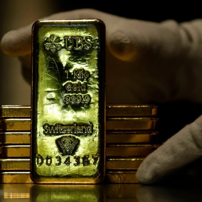 Employees of ProAurum gold house prepares 1 Kg gold bars of 999.9 purity in the safe deposit boxes room in Munich, Germany, Thursday, Dec. 13, 2018. (AP Photo/Matthias Schrader)