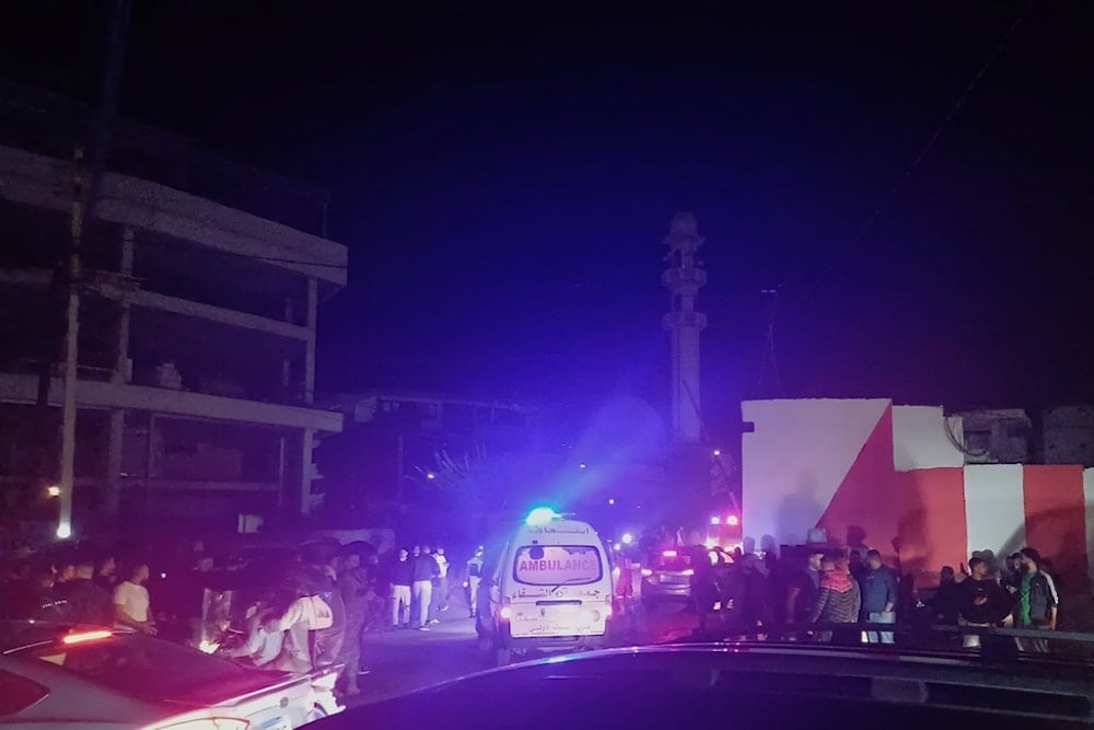 People gathering next to an ambulance as it enters the Ain el-Hilweh refugee camp in the southern port city of Sidon, Lebanon, Tuesday, November 18, 2025 (AP)