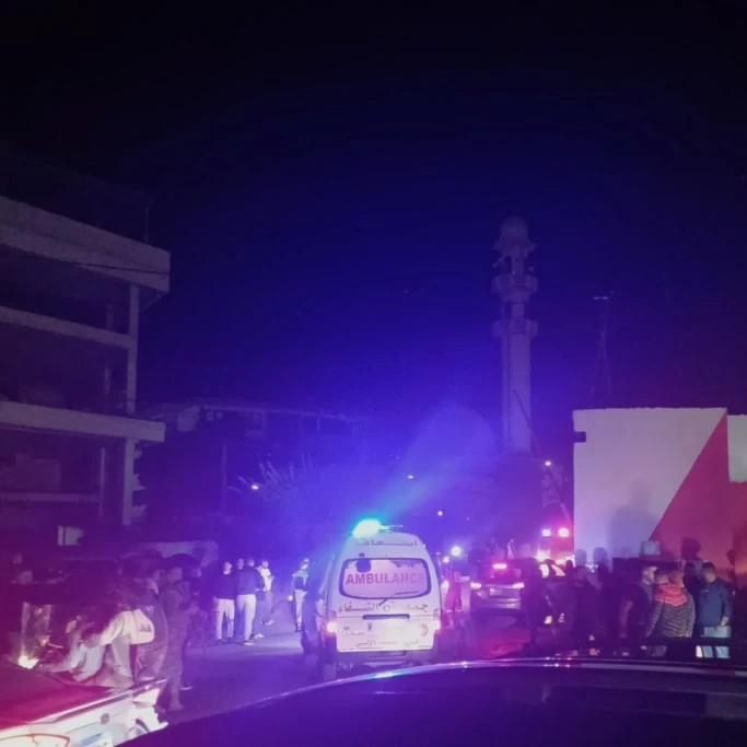 People gathering next to an ambulance as it enters the Ain el-Hilweh refugee camp in the southern port city of Sidon, Lebanon, Tuesday, November 18, 2025 (AP)